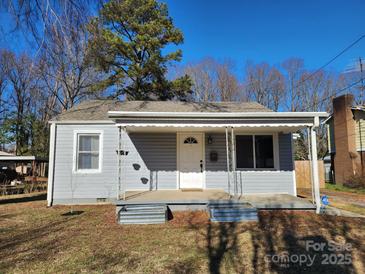 Gray house with a covered porch, and well-maintained lawn at 405 E 18Th St, Kannapolis, NC 28083