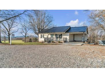 Newly renovated home with metal roof and gravel driveway at 50 Berea Church Quincy Rd, Hiddenite, NC 28636