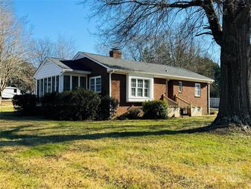 Brick ranch house with mature trees and a spacious yard at 813 S Zion St, Landis, NC 28088