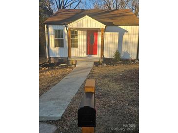 Charming white cottage with red door, walkway, and mailbox at 104 Rice St, Kannapolis, NC 28081