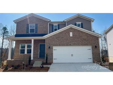 New construction two story brick home features a two car garage and a covered porch at 116 Sentinel Ct, Mooresville, NC 28115