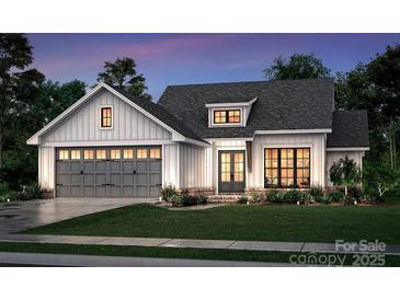Two-story craftsman style home with gray and white exterior, attached garage, and landscaped lawn at 117 Chavis Ln, Lincolnton, NC 28092