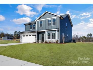 Gray house with white garage and stone accents at 3025 Swallowtail Ln, Kannapolis, NC 28083