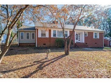 Brick ranch house with a landscaped yard and mature trees at 408 Elizabeth St, Gastonia, NC 28054