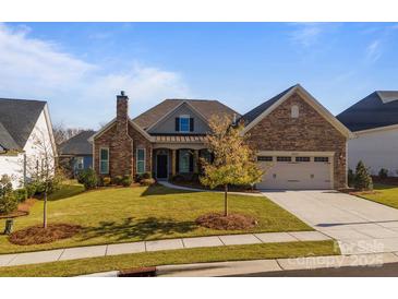 Inviting two-story home with stone accents and landscaped lawn at 82112 Standing Oak Dr, Charlotte, NC 28278