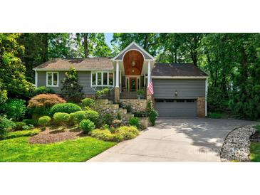 Gray house with stone steps, landscaping, and a two-car garage at 92 Heritage Dr, Clover, SC 29710