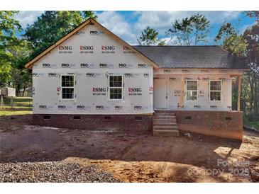 New construction home featuring brick foundation, steps to front door, and prepared yard for final grading at 1235 Ebinport Rd, Rock Hill, SC 29732