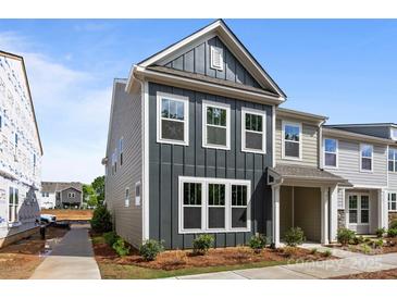 Charming two-story townhome with a modern gray exterior and well-manicured landscaping at 4121 Walking Ridge Rd # 54, Charlotte, NC 28208