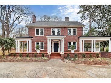 Brick home with a large front porch and landscaped yard at 106 Patrick St, Gastonia, NC 28054