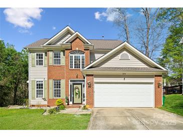 Charming two-story home featuring a well-maintained lawn, brick facade, and attached two-car garage at 3834 Sipes Ln, Charlotte, NC 28269