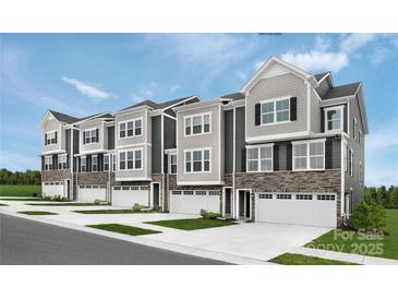 New townhome community with attached garages and landscaped yards at 5068 Grain Orchard Rd # 3022C, Indian Trail, NC 28079