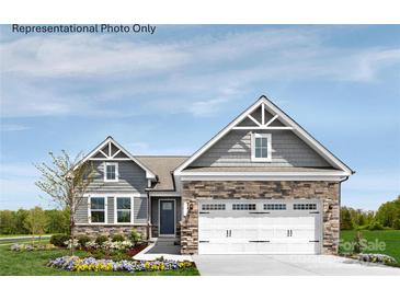 New single-story home with gray siding, stone accents, and a two-car garage at 599 Nesbe St # 2227, Lancaster, SC 29720