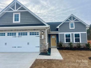 Gray two-story house with white garage door and a yellow front door at 599 Nesbe St # 2227, Lancaster, SC 29720