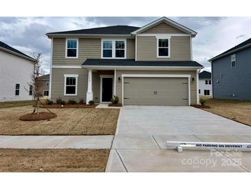 Charming two-story home featuring a neutral color scheme and a spacious two-car garage at 1412 Windy Park Dr, Stanley, NC 28164