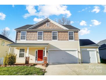 Two-story house featuring a two-car garage and red front door at 4005 Linville Falls Ln, Monroe, NC 28110