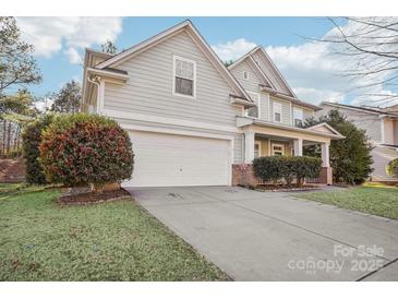 Gray sided two story house with a white garage door and landscaping at 8814 Beaver Creek Dr, Charlotte, NC 28269