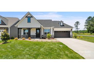 Craftsman style home with a two-car garage and manicured lawn at 917 Black Beard Dr, Denver, NC 28037