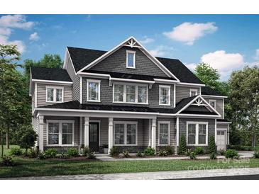 Two-story house with gray siding, white trim, and a covered porch at 1108 Sanderling Pl, Belmont, NC 28012