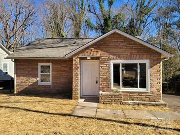 Newly renovated stone house with a landscaped yard at 1116 East Dr, Gastonia, NC 28052