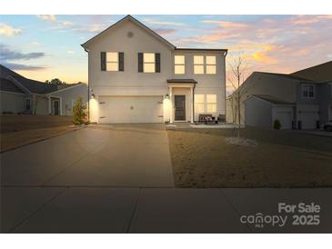 Charming two-story home featuring a two car garage, landscaped yard, and inviting front porch at 144 Mooring Dr, Statesville, NC 28677