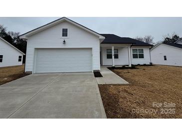 Newly constructed home with attached garage and walkway at 4111 Pebblebrook Sw Cir, Concord, NC 28027