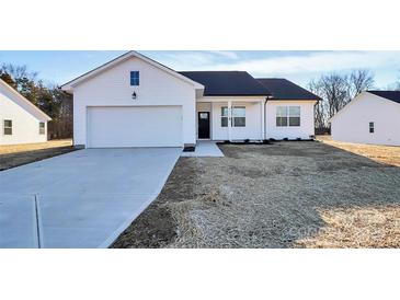 Newly constructed home with white siding, black roof, and a two-car garage at 4111 Pebblebrook Sw Cir, Concord, NC 28027