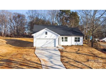 Newly constructed home with white siding and a dark roof at 4119 Pebblebrook Sw Cir, Concord, NC 28027