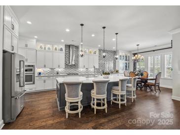 Stunning kitchen with an island, stainless steel appliances, and modern lighting at 7150 Irongate Dr, Indian Land, SC 29707