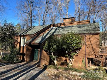 A charming brown wood home nestled among the trees at 807 Brunson Dr, Albemarle, NC 28001