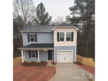 Two-story house with blue and beige siding, a white garage door, and landscaping at 1252 Old Greenbriar Dr, Lancaster, SC 29720