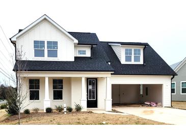 Charming two-story home featuring a black roof, black door, and attached garage at 13605 Tranquil Day Dr, Matthews, NC 28105