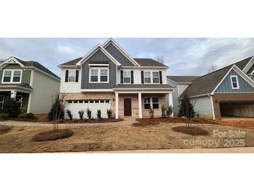 Two-story home with gray and white siding, brick accents, and a landscaped lawn at 139 Ella Claire Dr, York, SC 29745