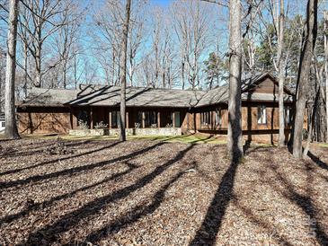 Ranch home with wood siding, stone accents & covered porch at 217 Wellington Dr, Matthews, NC 28104