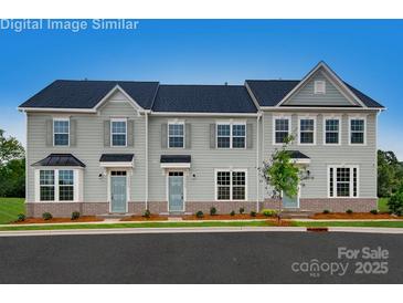 Three-unit townhome exterior, showcasing a modern design and attractive landscaping at 421 Serenity Cir, Cramerton, NC 28032