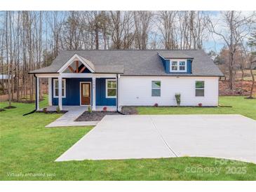 Charming blue and white home with a covered porch, stone walkway, and well-manicured lawn at 108 Robinson Dr, Cherryville, NC 28021