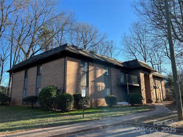 Brick building exterior with landscaping and parking at 133 Orchard Trace Ln # 5, Charlotte, NC 28213