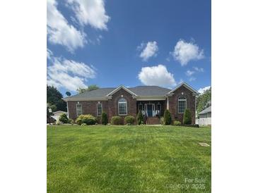 Beautiful single-story brick house with arched windows and a well-maintained lawn at 1601 Eden Glen Dr, Dallas, NC 28034