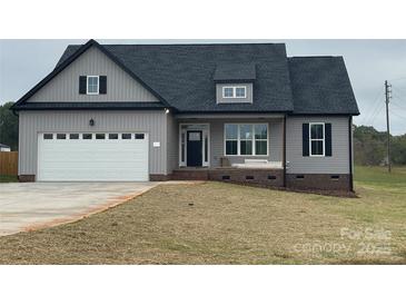 Gray siding house with white garage door and landscaping at 208 Beths Ct # 35, York, SC 29745