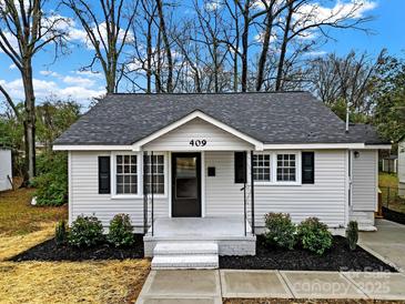 Charming renovated home with a white exterior, gray roof, and landscaped yard at 409 Jones S Ave, Rock Hill, SC 29730
