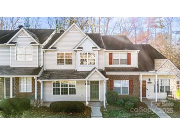 Brick front exterior of charming townhome with green door at 6855 Juniper Tree St, Charlotte, NC 28215