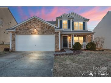 Two-story house with stone accents and a two-car garage at 9321 Bayview Pkwy, Charlotte, NC 28216