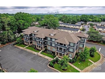 Modern building with parking and city skyline view at 935 Mcalway Rd # 306, Charlotte, NC 28211