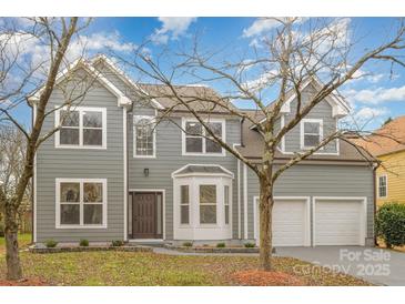 Two-story house with gray siding, two-car garage, and landscaped lawn at 11519 Laurel View Dr, Charlotte, NC 28273