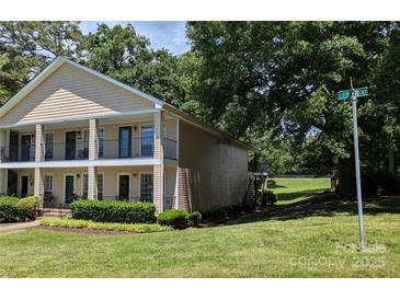 Inviting townhouse showcasing a quaint balcony and neat landscaping enhancing its curb appeal at 1985 Lancer Ct, Gastonia, NC 28054