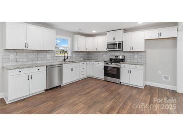 Modern white kitchen with granite countertops at 307 E Old Highway 74 None, Monroe, NC 28112