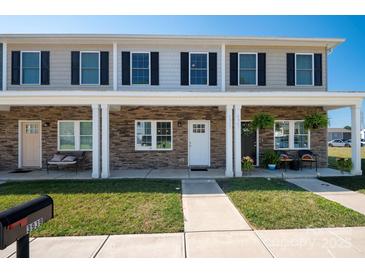 Two-story townhome with stone accents and covered porch at 3939 Newhall Dr, Hickory, NC 28601
