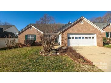 Brick ranch home with attached garage and landscaped lawn at 730 Hidden Creek Cir, Salisbury, NC 28147