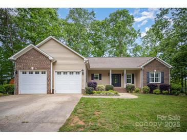 Charming single-story home with a brick-accented facade, attached two-car garage, and well-manicured lawn at 1313 Western Hills Ln, Vale, NC 28168