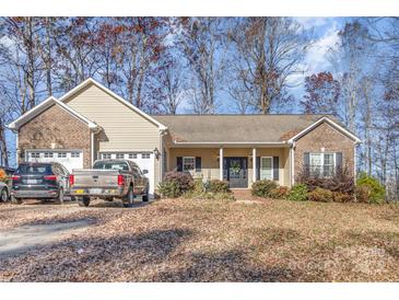 Brick ranch home with attached two-car garage and landscaped yard at 1313 Western Hills Ln, Vale, NC 28168