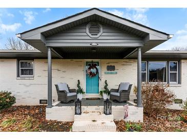 Charming ranch home with gray roof and teal front door at 1535 Rolling Meadow Ln, Gastonia, NC 28054
